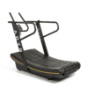 ADVG CurveMax commercial curved manual treadmill, all-black with yellow accent stripe, front three-quarter studio view
