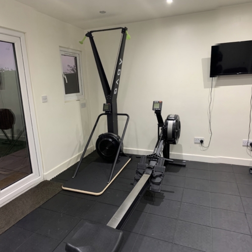ADVG SkiErg RowErg Bundle in a home gym with black rubber floor tiles