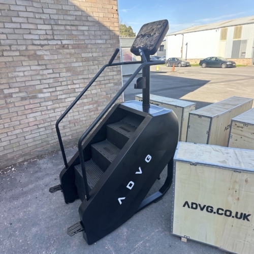ADVG StepMaster 1.0 side view with the logo panel and handrails, outside the warehouse